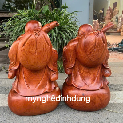 Tượng phật di lặc dắt cò bằng gỗ hương đá cao 40cm